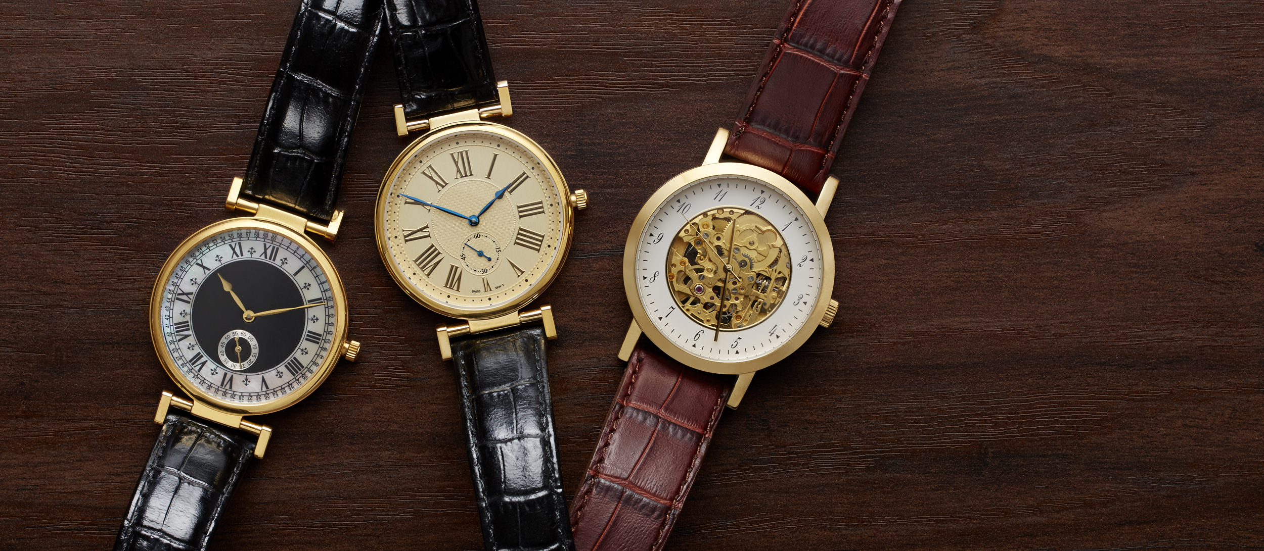 e-commerce header of three gold and leather mens watches on wood background